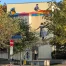 The street art mural "Toxic Colours are Beautiful" by LAPIZ fits perfectly in the surrounding nature. All elements of the painting can be seen: a colourful toxic river with two child labors, colourful rain dripping down the gigantic wall and a kid dancing in it.